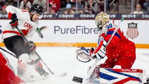 Canada's Tij Iginla (11) attacks the net defended by Czechia goaltender Michal Orsulak (30) during second period IIHF World Junior Championship hockey action, in Minneapolis, Friday, Dec. 26, 2025. THE CANADIAN PRESS/Christopher Katsarov
