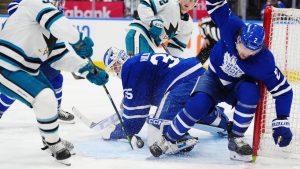 Toronto Maple Leafs goaltender Dennis Hildeby (35) makes a save on San Jose Sharks' Jeff Skinner (53) as Maple Leafs' Simon Benoit (2) defends during third period NHL hockey action in Toronto on Thursday, Dec. 11, 2025. (Frank Gunn/CP)