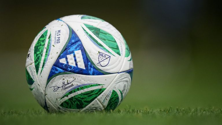 A soccer ball with the MLS logo and Commissioner Don Garber's signature sits on the pitch as the Vancouver Whitecaps practice, in Vancouver, on Wednesday, Oct. 22, 2025. (Darryl Dyck/CP)
