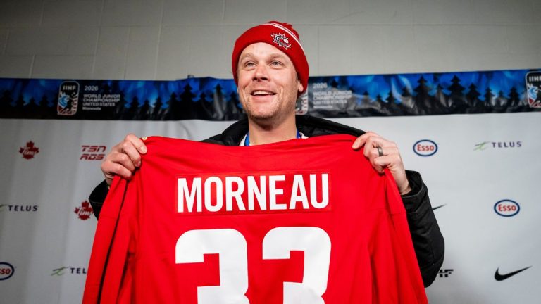 Canadian former professional baseball player Justin Morneau is gifted a Team Canada jersey with his Minnesota Twins team number, during a press conference at the IIHF World Junior Championship hockey, in Minneapolis, Minn., on Monday, Dec. 29, 2025. (Christopher Katsarov/CP)