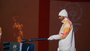 Italian swimmer Gregorio Paltrinieri lights the 2026 Milan Cortina Winter Olympics torch in Rome as it begins its journey through Italy, Saturday, Dec. 6, 2025, a journey that will conclude in Milan in February 2026. (Andrew Medichini/AP)