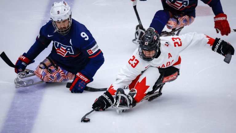 Team USA forward Travis Dodson (9) chases Team Canada forward Liam Hickey (23) during first period action in the World Para Ice Hockey Championship final in Calgary, Sunday, May 12, 2024. (Jeff McIntosh/CP)