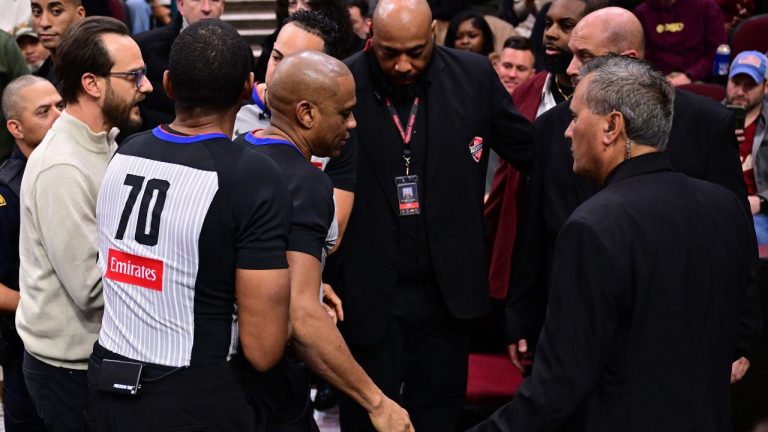 Referee Tre Maddox, centre, is assisted by referee Phenizee Ransom and members of the training staff after sustaining an injury running off the floor the first half of an NBA basketball game between the Cleveland Cavaliers and Chicago Bulls, Friday, Dec. 19, 2025, in Cleveland. (David Dermer/AP)
