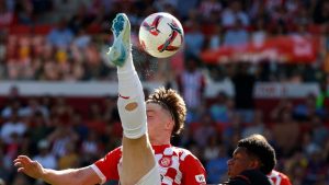 Girona's Viktor Tsygankov, left, challenges for the ball with Barcelona's Alejandro Balde during the Spanish La Liga soccer match between Girona and Barcelona at the Montilivi stadium in Girona, Spain, Sunday, Sept. 15, 2024. (Joan Monfort/AP)