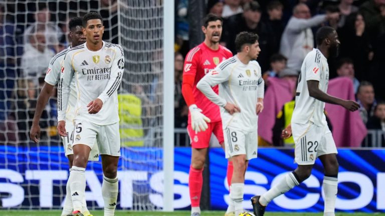 Real Madrid's Jude Bellingham, left, and teammates react after Celta's Williot Swedberg scored his side's second goal during the Spanish La Liga match between Real Madrid and Celta Vigo in Madrid, Spain, Sunday, Dec. 7, 2025. (Manu Fernandez/AP)