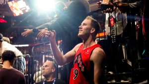 Toronto Raptors Jakob Poeltl takes a selfie with fans after NBA basketball action against Cleveland Cavaliers in Toronto, Monday, Nov. 24, 2025. (Chris Young/CP)
