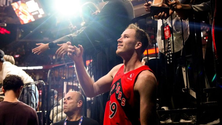 Toronto Raptors Jakob Poeltl takes a selfie with fans after NBA basketball action against Cleveland Cavaliers in Toronto, Monday, Nov. 24, 2025. (Chris Young/CP)