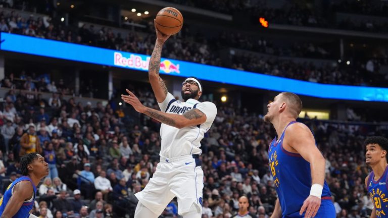 Dallas Mavericks centre Anthony Davis goes up for a basket as Denver Nuggets centre Nikola Jokić defends in the first half of an NBA basketball game Monday, Dec. 1, 2025, in Denver. (David Zalubowski/AP)