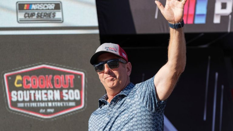 Former driver Greg Biffle waves to fans prior to a NASCAR Cup Series auto race at Darlington Raceway, Sunday, Aug. 31, 2025, in Darlington, S.C. (Matt Kelley/AP)