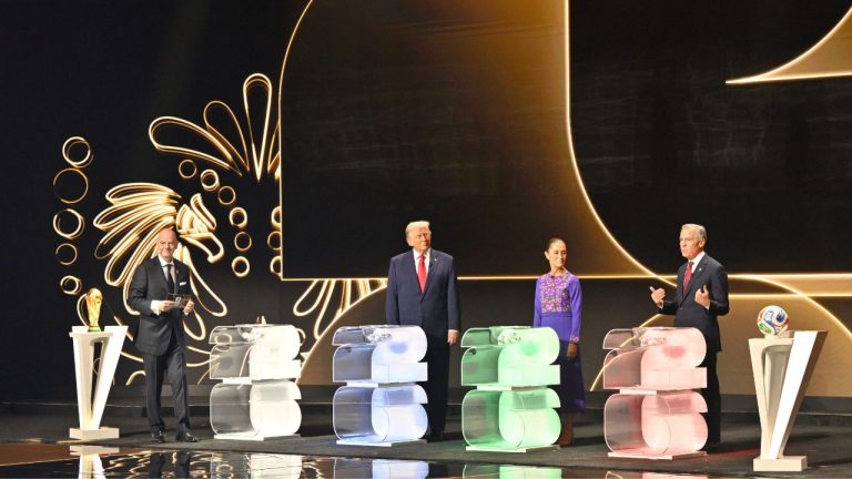 FIFA President Gianni Infantino, left, President Donald Trump, Mexican President Claudia Sheinbaum look on as Canadian Prime Minister Mark Carney speaks on state at the draw for the 2026 soccer World Cup at the Kennedy Center in Washington, Friday, Dec. 5, 2025. (Mandel Ngan/AP)