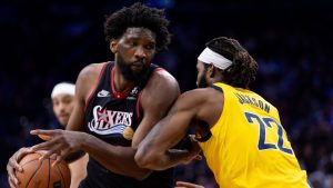 Philadelphia 76ers' Joel Embiid, left, drives to the basket against Indiana Pacers' Isaiah Jackson, right, during the first half of an NBA basketball game, Friday, Dec. 12, 2025, in Philadelphia. (Chris Szagola/AP)