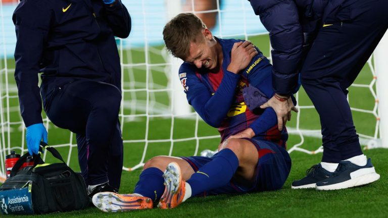 Barcelona's Dani Olmo reacts in pain in his arm after scoring his side's second goal during a Spanish La Liga soccer match between Barcelona and Atletico de Madrid, in Barcelona, Spain, Tuesday, Dec.2, 2025. (Joan Monfort/AP)