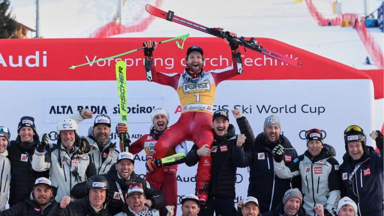 Austria's Marco Schwarz, centre top, celebrates with the team after winning an alpine ski, men's World Cup Giant slalom, in Alta Badia, Italy, Sunday Dec. 21, 2025. (Alessandro Trovati/AP)