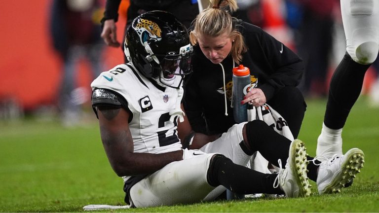 Jacksonville Jaguars cornerback Jourdan Lewis is tended to after being injured in the second half of an NFL football game Sunday, Dec. 21, 2025, in Denver. (AP Photo/David Zalubowski)