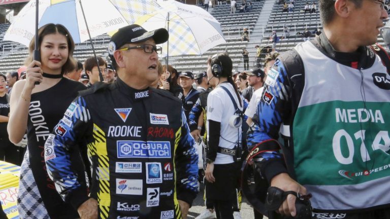 Toyota Chairman Akio Toyoda, center, stands next to the racing car powered by liquid hydrogen he drove during a 24-hour race at Fuji International Speedway in Oyama town, some 100 kilometers southwest of Tokyo, Saturday, May 27, 2023. (AP Photo/Yuri Kageyama)