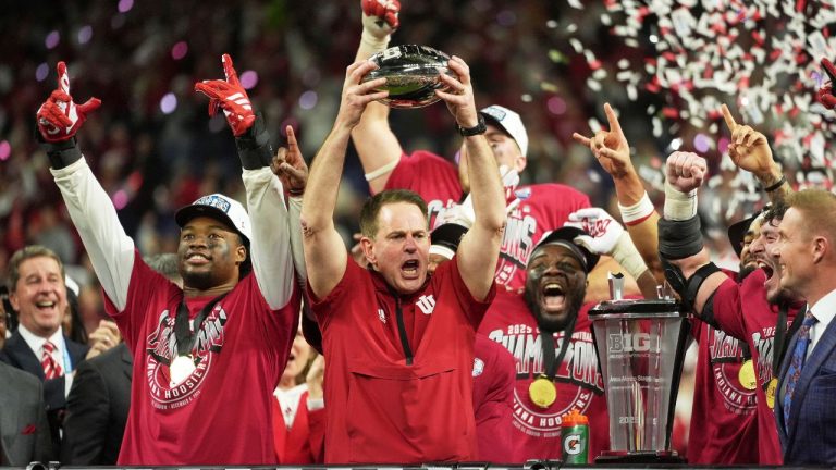 Indiana head coach Curt Cignetti holds up the championship trophy after the Big Ten championship NCAA college football game against Ohio State in Indianapolis, Saturday, Dec. 6, 2025. (AP Photo/Michael Conroy)