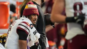 Washington Commanders quarterback Jayden Daniels on the bench before a game against the Minnesota Vikings, Sunday, Dec. 7, 2025, in Minneapolis. (AP Photo/Abbie Parr)