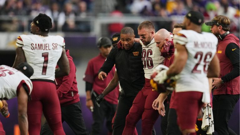Washington Commanders tight end Zach Ertz (86) is helped to walk off the field after an injury during the second half of an NFL game against the Minnesota Vikings, Sunday, Dec. 7, 2025, in Minneapolis. (AP Photo/Abbie Parr)