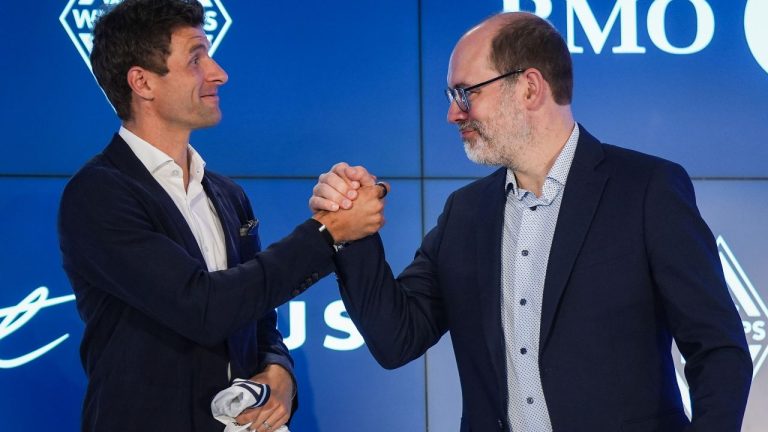 New Vancouver Whitecaps player Thomas Muller, left, and Whitecaps CEO and sporting director Axel Schuster shake hands after a news conference in Vancouver, on Thursday, Aug. 14, 2025. (Darryl Dyck/CP)