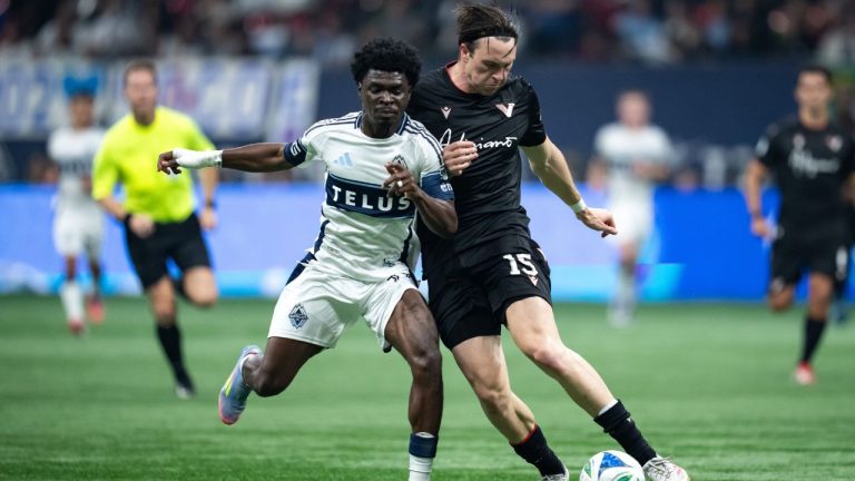Vancouver Whitecaps' Emmanuel Sabbi (11) and Vancouver FC's Aidan O'Connor (15) vie for the ball during the second half of the Canadian Championship final soccer match, in Vancouver, on Wednesday, October 1, 2025. (Ethan Cairns/THE CANADIAN PRESS)