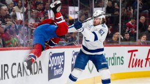 Tampa Bay Lightning' Charle-Edouard D'Astous (51) hits Montreal Canadiens' Brendan Gallagher (11) during first period NHL hockey action in Montreal on Tuesday, Dec. 9, 2025. (Christopher Katsarov/THE CANADIAN PRESS)