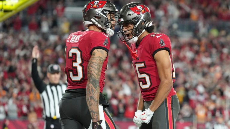 Tampa Bay Buccaneers wide receiver Mike Evans (13) celebrates with fellow Buccaneers receiver Jalen McMillan (15) during an NFL Wild Card playoff game against the Washington Commanders, Sunday, Jan 12, 2025, in Tampa, Fla. (AP Photo/Peter Joneleit)