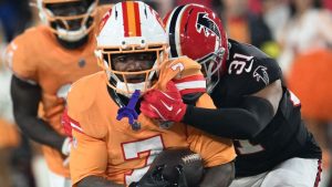 Tampa Bay Buccaneers running back Bucky Irving runs against Atlanta Falcons safety Xavier Watts during the an NFL game, Thursday, Dec. 11, 2025, in Tampa, Fla. (AP Photo/Jason Behnken)