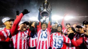 Atletico Ottawa's Ballou Tabla (13) raises the North Star Cup following Atletico Ottawa’s victory over Cavalry FC in extra time during the Canadian Premier League finals soccer action in Ottawa, on Sunday, Nov. 9, 2025. (Spencer Colby/THE CANADIAN PRESS)