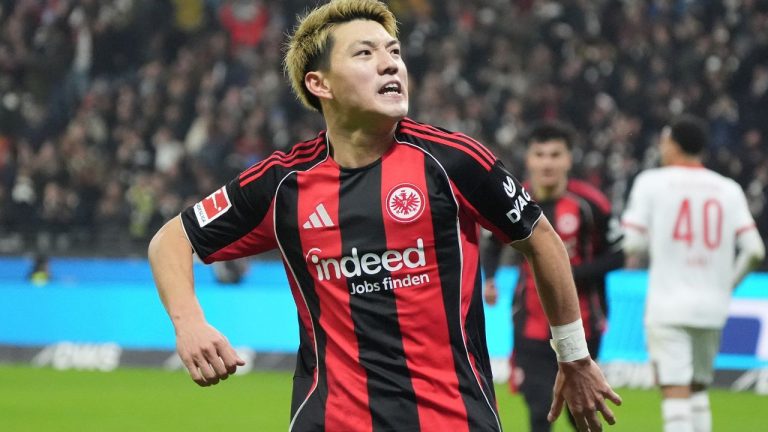 Frankfurt's Ritsu Doan celebrates after scoring the opening goal during the Bundesliga match between Eintracht Frankfurt and FC Augsburg in Frankfurt, Germany, Saturday, Dec. 13, 2025. (Marc Schueler/dpa via AP)