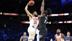 New York Knocks centre Karl-Anthony Towns (32) and Orlando Magic forward Jonathan Isaac (1) tangle near the net during the first half of an NBA Cup semifinals basketball game, Saturday, Dec. 13, 2025, in Las Vegas. (Ronda Churchill/AP)