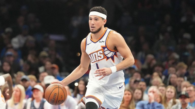 Phoenix Suns guard Devin Booker pushes down the court during the first half of an NBA Cup basketball game against the Oklahoma City Thunder, Friday, Nov. 28, 2025, in Oklahoma City. (Kyle Phillips/AP)