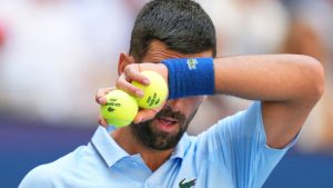 Novak Djokovic, of Serbia, wipes sweat from his face between serves during the second round of the U.S. Open tennis championships, Wednesday, Aug. 27, 2025, in New York. (AP Photo/Kirsty Wigglesworth)