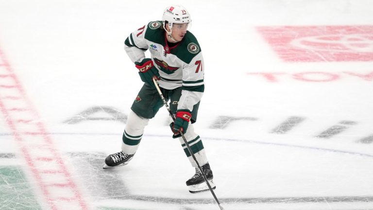 Minnesota Wild defenseman Carson Lambos controls the puck during a preseason NHL hockey game against the Dallas Stars, Tuesday, Sept. 26, 2023, in Dallas. (Tony Gutierrez/AP)