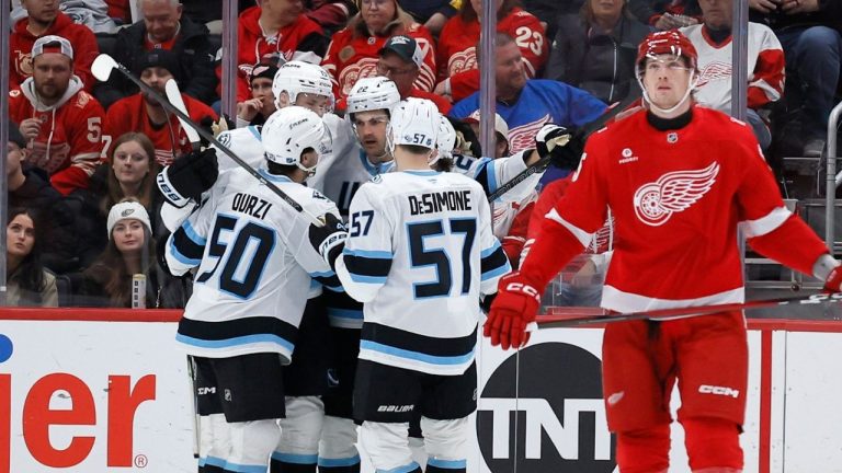 Utah Mammoth centre Jack McBainm (22), third from left, with defenceman Sean Durzi (50), centre Alexander Kerfoot (15) and defenceman Nick Desimone (57) after scoring against the Detroit Red Wings Wednesday, Dec. 17, 2025, in Detroit. (AP Photo/Duane Burleson)