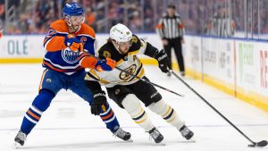 Boston Bruins' David Pastrnak (88) battles for the puck against Edmonton Oilers' Connor McDavid (97) during third period NHL action in Edmonton on Thursday, December 19, 2024. (Timothy Matwey/THE CANADIAN PRESS)