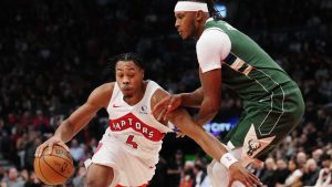 Toronto Raptors' Scottie Barnes (4) drives past Milwaukee Bucks' Myles Turner (3) during first half NBA basketball action in Toronto on Tuesday, November 4, 2025. (Nathan Denette/THE CANADIAN PRESS)