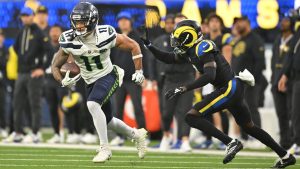 Seattle Seahawks wide receiver Jaxon Smith-Njigba, left, runs the ball as Los Angeles Rams cornerback Emmanuel Forbes chases him during the second half of an NFL football game Sunday, Nov. 16, 2025, in Inglewood, Calif. (Katie Chin/AP)