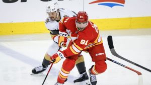 Vegas Golden Knights' Tomas Hertl, left, chases Calgary Flames' Nazem Kadri during third period NHL hockey action in Calgary on Tuesday, Oct. 14, 2025. (Jeff McIntosh/THE CANADIAN PRESS)