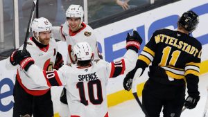 Ottawa Senators' Claude Giroux (28) celebrates after his goal with teammates Dylan Cozens (24) and Jordan Spence (10) during the first period of an NHL hockey game against the Boston Bruins in Boston, Sunday, Dec. 21, 2025. (CJ Gunther/AP)