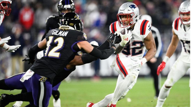 New England Patriots running back Tre'Veyon Henderson (32) runs against Baltimore Ravens safety Alohi Gilman (12) during the first half of an NFL football game, Sunday, Dec. 21, 2025, in Baltimore. (Nick Wass/AP)