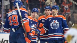 Edmonton Oilers' Leon Draisaitl (29), Ryan Nugent-Hopkins (93), Connor McDavid (97) and Evan Bouchard (2) celebrate a goal against the Vegas Golden Knights during second period NHL action, in Edmonton on Sunday, December 21, 2025. (Jason Franson/THE CANADIAN PRESS)