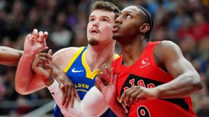 Golden State Warriors centre Quinten Post (21) and Toronto Raptors forward RJ Barrett (9) watch for the rebound during first half NBA basketball action in Toronto, Sunday, Dec. 28, 2025. (Frank Gunn/THE CANADIAN PRESS)