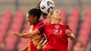 Canada's Holly Ward (27) and Ashley Lawrence compete for a header during first half international women's friendly soccer action against Costa Rica in Toronto, on Friday June 27, 2025. (CP/Chris Young)