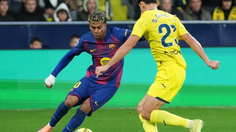 Barcelona's Lamine Yamal, left, duels for the balls with Villarreal's Sergi Cardona during the Spanish La Liga match between Villarreal and Barcelona in Villarreal, Spain, Sunday, Dec. 21, 2025. (AP/Alberto Saiz)