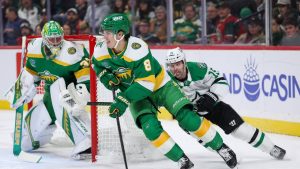 Minnesota Wild defenseman Zeev Buium, left, skates with the puck as Dallas Stars center Colin Blackwell (15) defends during the first period of an NHL hockey game Thursday, Dec. 11, 2025, in St. Paul, Minn. (Matt Krohn/AP)