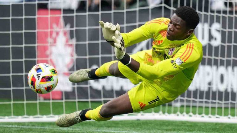 Toronto FC goalkeeper Sean Johnson stops Vancouver Whitecaps' Stuart Armstrong, not seen, during penalty kicks in the Canadian Championship final soccer match, in Vancouver, on Wednesday, September 25, 2024. (Darryl Dyck/CP)