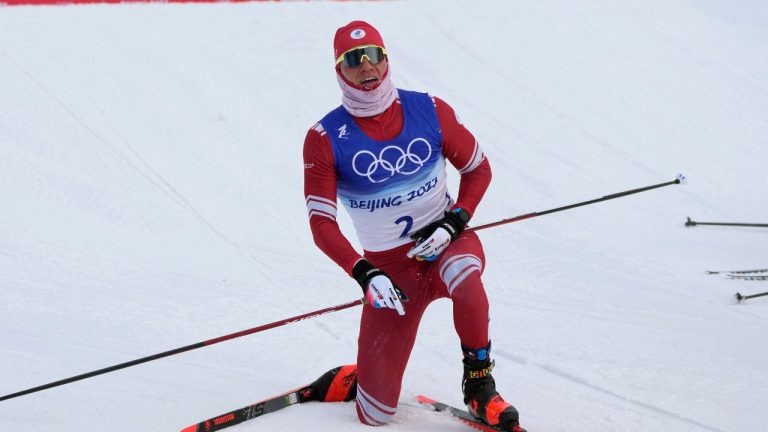 Russian athlete Alexander Bolshunov reacts after crossing the finish line during the men's weather-shortened 50km mass start free cross-country skiing competition at the 2022 Winter Olympics, Saturday, Feb. 19, 2022, in Zhangjiakou, China. (Alessandra Tarantino/AP)