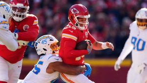 Kansas City Chiefs quarterback Patrick Mahomes (15) is sacked by Los Angeles Chargers outside linebacker Tuli Tuipulotu, left, during the first half of an NFL football game. (Charlie Riedel/AP)