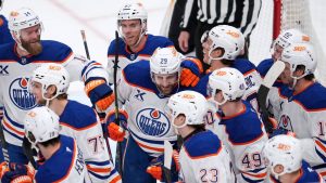 Edmonton Oilers' Leon Draisaitl (29) is swarmed by teammates after scoring during the first period of an NHL hockey game against the Pittsburgh Penguins in Pittsburgh, Tuesday, Dec. 16, 2025. (Gene J. Puskar/AP)