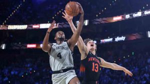 San Antonio Spurs guard De'Aaron Fox (4) shoots against New York Knicks guard Tyler Kolek (13) during the first half of the NBA Cup championship basketball game Tuesday, Dec. 16, 2025, in Las Vegas. (Ian Maule/AP)